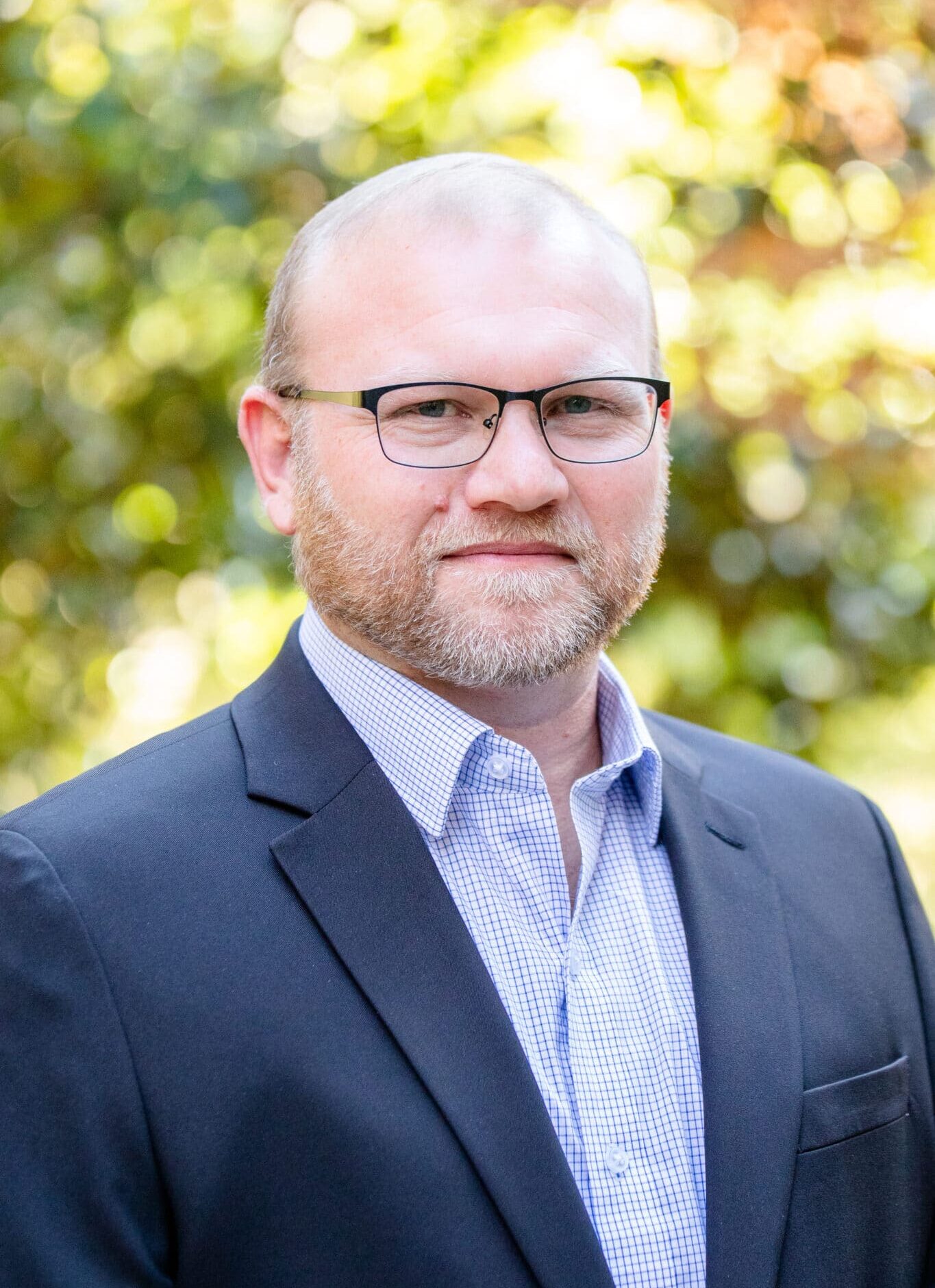 a man wearing glasses and a suit and tie