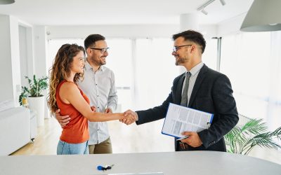 Real Estate Agent With Couple Shaking Hands Closing A Deal